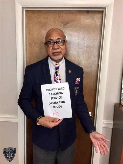 a man in a suit holding a sign