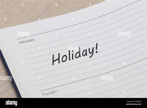 Holiday reminder note in a diary page Stock Photo - Alamy