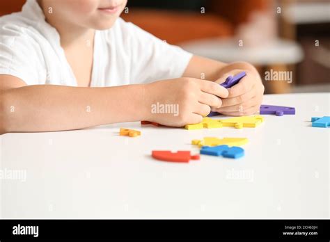 Little boy with autistic disorder doing puzzle at home Stock Photo - Alamy