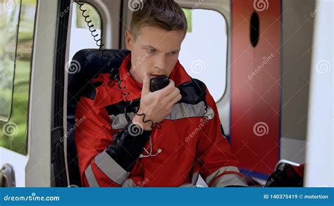 Male Paramedic Talking by Radio, Sitting in Ambulance, Ready To Drive on Call Stock Image ...