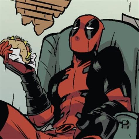 deadpool sitting in a chair eating a hot dog