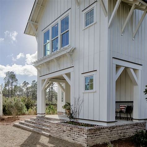 a large white house sitting on top of a dirt field