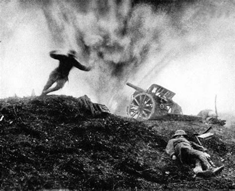 German soldier dives for cover as shell explodes behind him at an artillery position, 1917 ...