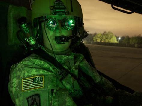 'Pilot Equipped with Night Vision Goggles in the Cockpit of An Apache ...