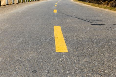 Premium Photo | Yellow broken line on asphalt road, road marking