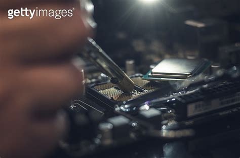 Computer repair man installing a CPU on mother board. Repair of central ...