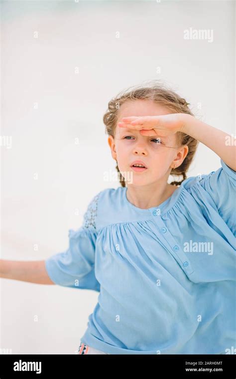 Adorable little girl walking on the beach Stock Photo - Alamy