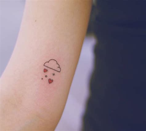 Love cloud tattoo on the inner arm.