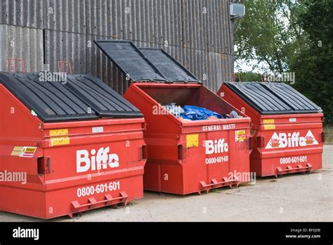 Three large red commercial waste bins, Industrial waste Stock Photo - Alamy