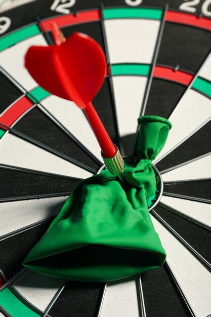 Premium Photo | Hitting the target darts and ball in the center