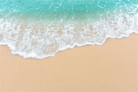 Summer beach concept of an ocean wave on empty sandy beach 1226527 Stock Photo at Vecteezy