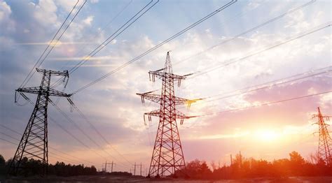 High-voltage power lines at sunset or sunrise. High voltage electric ...