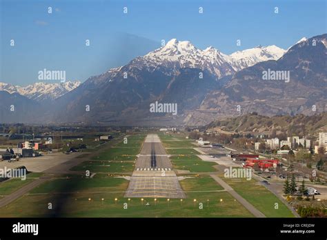 Military airport runway on landing approach. Taken from cockpit of small private plane Stock ...