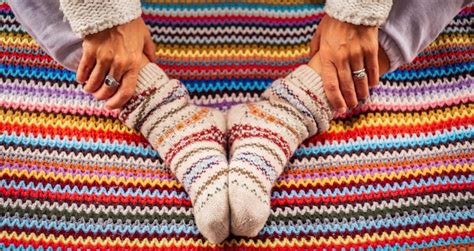 Premium Photo | Above view of woman feet with colorful socks and knitted wool cover concept of ...