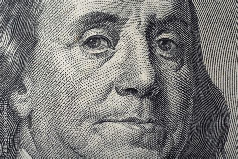 Portrait of Ben Franklin on the US 100 dollar bill in macro. Benjamin Franklin on hundred dollar ...