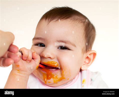 Baby eating baby food Stock Photo - Alamy