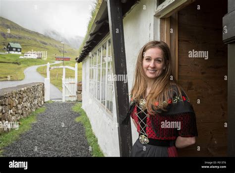 Faroese girl wearing traditional clothes outside the church of Stock ...