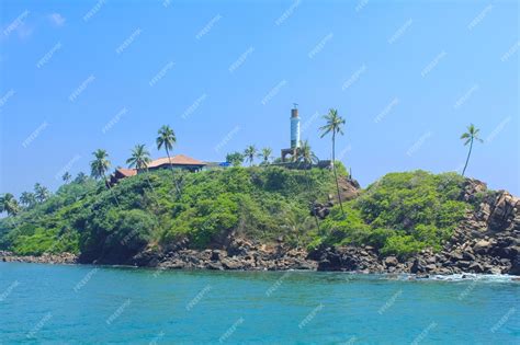 Premium Photo | Close up on the lighthouse on the coast of mirissa sri lanka view from the boat ...