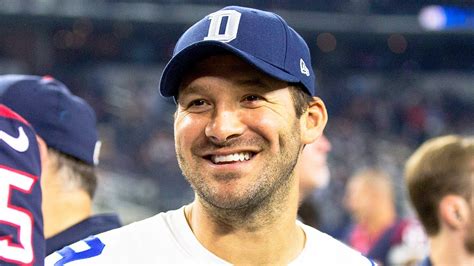 a man in a baseball cap smiles at the camera while standing next to ...