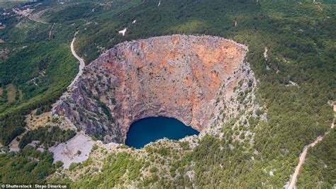 Into the abyss: Incredible images of the world's most stunning sinkholes, from Oregon to ...