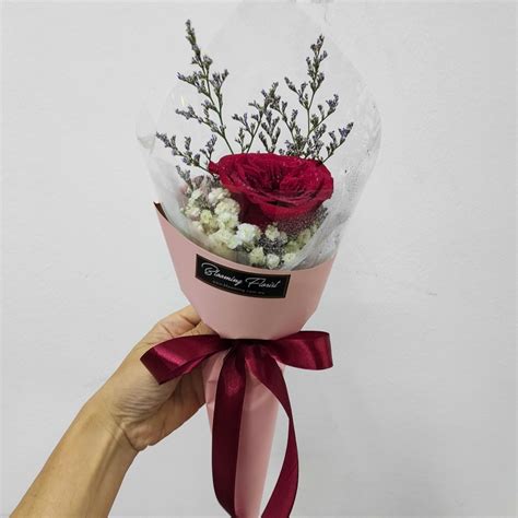 Single red rose in a hand bouquet - Blooming