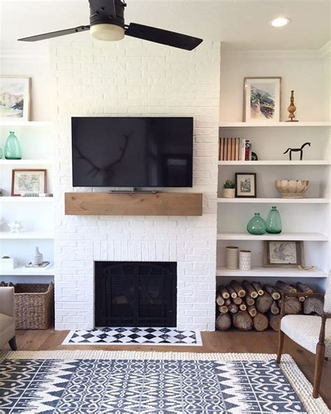 a living room filled with furniture and a flat screen tv mounted above ...