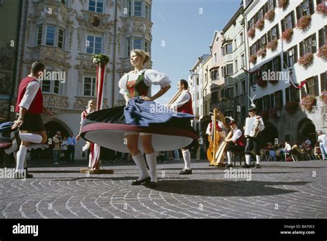 Austria Tyrol Innsbruck street folk dance-group folklore culture Schuhplattler woman dances city ...