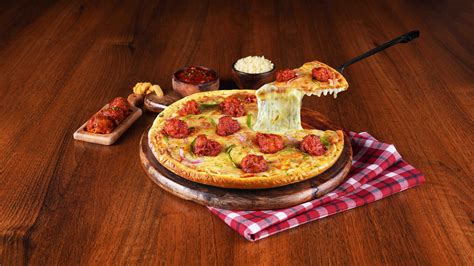 Order Schezwan Chicken Cheese Burst Pizza online from Ovenstory