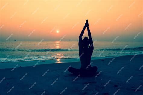 Free Photo | Silhouette of woman doing yoga on a beach