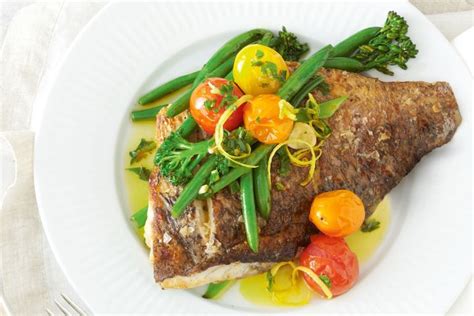 Crispy-skinned barramundi with garlic and herb oil