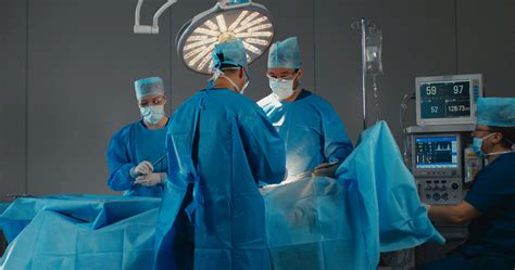 Medical team, doctors performing surgical operation in modern operating ...