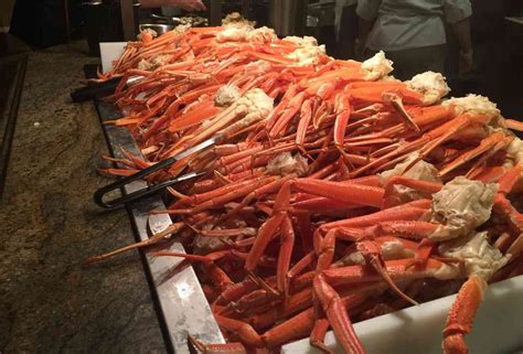 a large pile of lobsters sitting on top of a counter