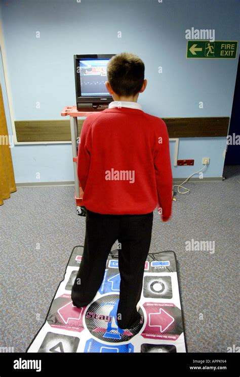 kid boy playstation game computer school dance mat dancemat male physical Stock Photo - Alamy