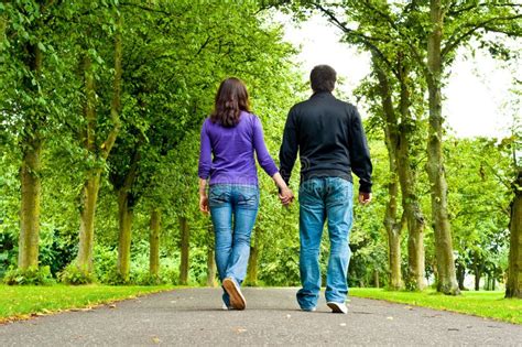 Couple Holding Hands And Walking In A Park Royalty Free Stock Image - Image: 15421956