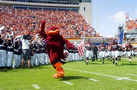 Virginia Tech - mascot HokieBird leading football team onto the field ...