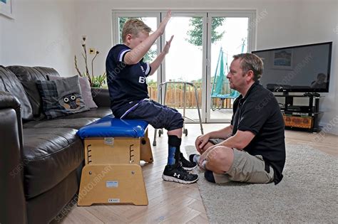 Cerebral palsy patient doing exercises - Stock Image - C038/2343 - Science Photo Library