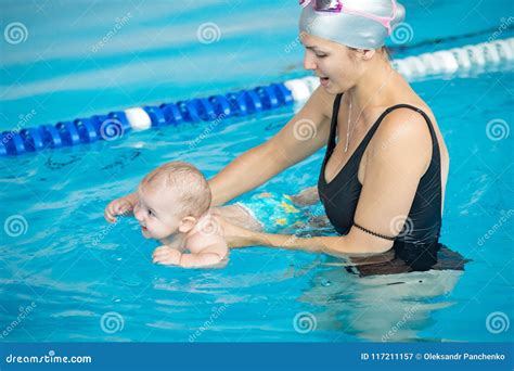 Mother Teach Her Baby, How To Swim in a Swimming Pool Stock Image ...