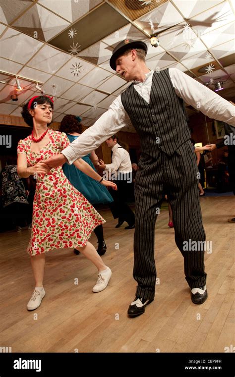 People swing dancing Lindy hopping and jiving to retro 40s 50s music at a club, UK Stock Photo ...