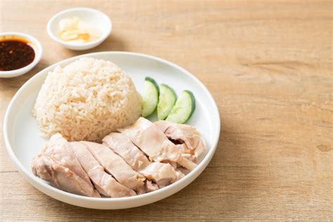 Premium Photo | Hainanese chicken rice or rice steamed with chicken soup