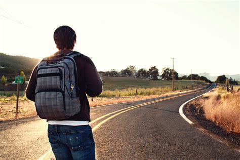 Man Walking on Road Under the Sun · Free Stock Photo