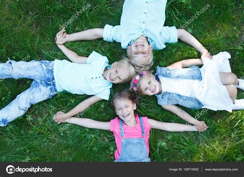 Children laying grass Stock Photo by ©ALotOfPeople 138713932