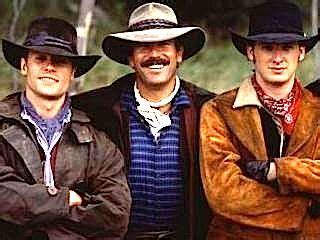 three men wearing hats and jackets are posing for the camera with their arms crossed in front of ...