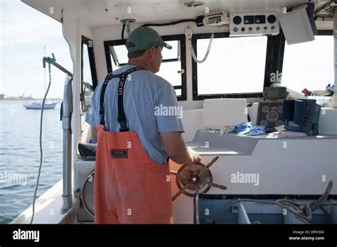 Lobsterman Eric Emmons driving lobster boat Stock Photo - Alamy