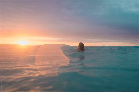 Young Girl Swimming Alone At Sunset by Alison Winterroth - Swim, Water - Stocksy United