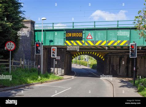 Low bridge warning sign on railway bridge in Cheshire UK Stock Photo - Alamy