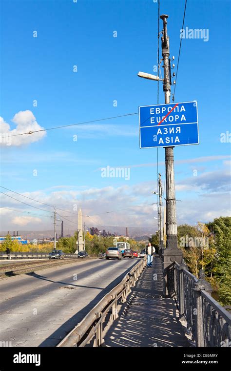 Road sign about Europe and Asia border in Ural river. It is located on vehicular bridge in city ...