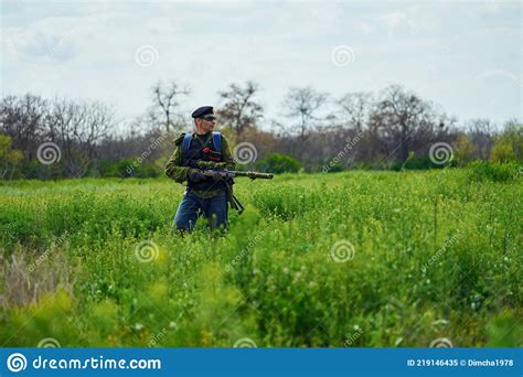 Airsoft Player in Camouflage Military Uniform Holds a Rifle in His ...