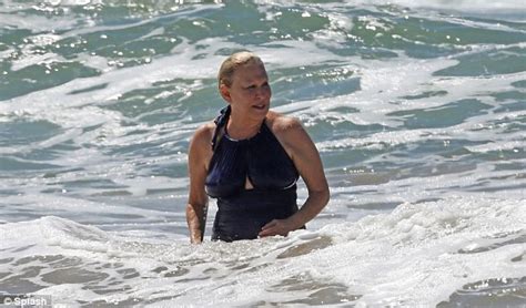 Bette Midler takes a dip in the Pacific after hitting the beach in a ...