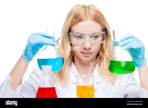 Chemist with multi-colored test tubes on a white background while working Stock Photo - Alamy