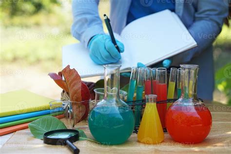 Science experiment, colorful liquid substaance in transparent test bottles. Obsserve, take note ...